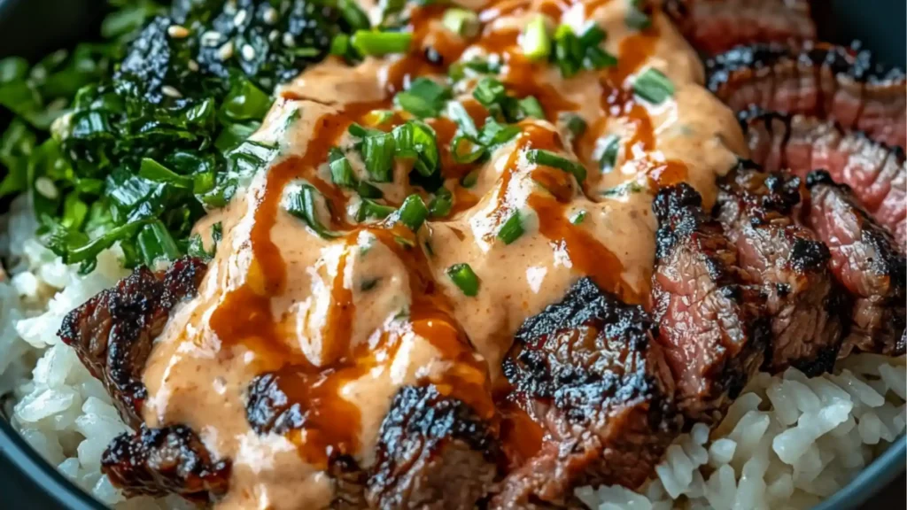 korean bbq steak rice bowl with sauce and green onions on the side in a black bowl