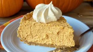 no bake pumpkin fluff pie on a white plate with a blue sign that says, no bake pumpkin fluff pie easy pumpkin dessert