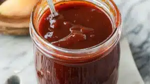 homemade rhubarb barbecue sauce in a jar with spoon