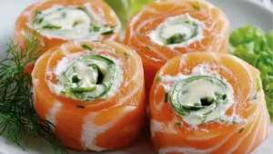 smoked salmon rolls with avocado on top and sprinkles in the middle