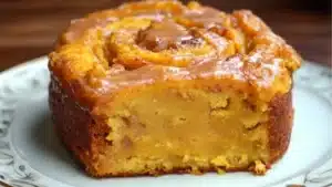 sweet potato cinnamon roll cake on a white plate with the words sweet potato cinnamon roll cake above it