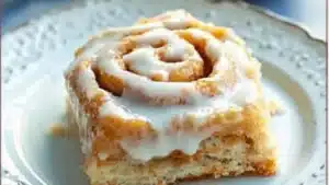 pumpkin cinnamon rolls on a plate with a fork