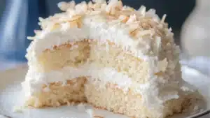 two pieces of coconut cloud cake on a plate with the words coconut cloud cake recipe