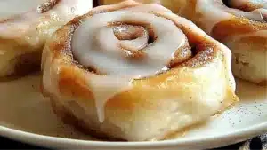 cinnamon rolls on a plate with icing drizzled over them and the words gluten - free mochi cinnamon rolls