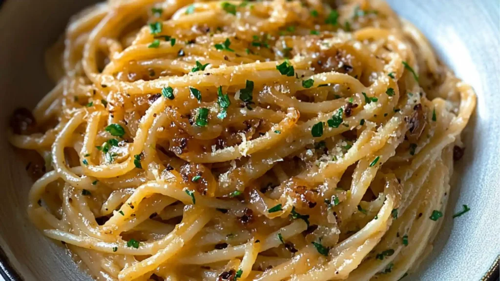 caramelized onion pasta on a plate with text overlay