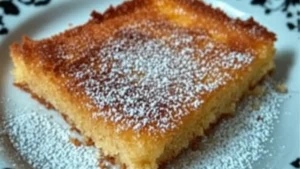 pumpkin spice magic custard cake is cut into squares and put on a plate