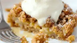 pumpkin pie crisp with cinnamon streusel and whipped cream on top in black pans