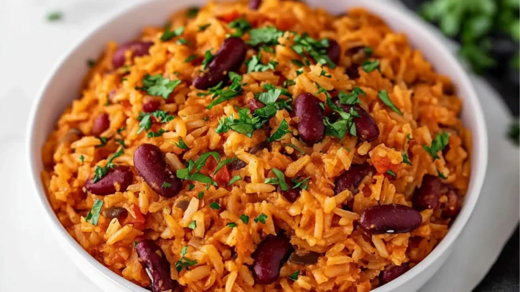 spanish rice and beans in a bowl with spoons
