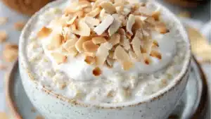 coconut cream pie overnight oatmeal in two jars with text overlay that reads easy homemade coconut cream pie overnight oats