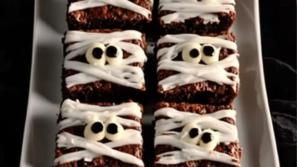 someone is decorating some brownies with fake eyes and bones on them for halloween