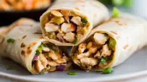 thai chicken wraps on a plate with dipping sauce