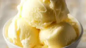 a bowl filled with ice cream next to a pineapple on the side and text overlay that reads, ninja cream dole whip
