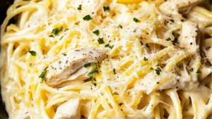 lemon chicken pasta in a skillet with text overlay