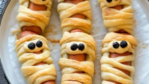 Golden-brown crescent roll mummy hot dogs, with the recipe