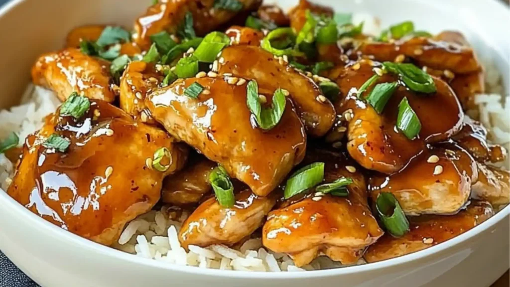 crockpot honey garlic chicken in a white pot with text overlay that reads, crockpot honey garlic chicken done in just 6 ingredients