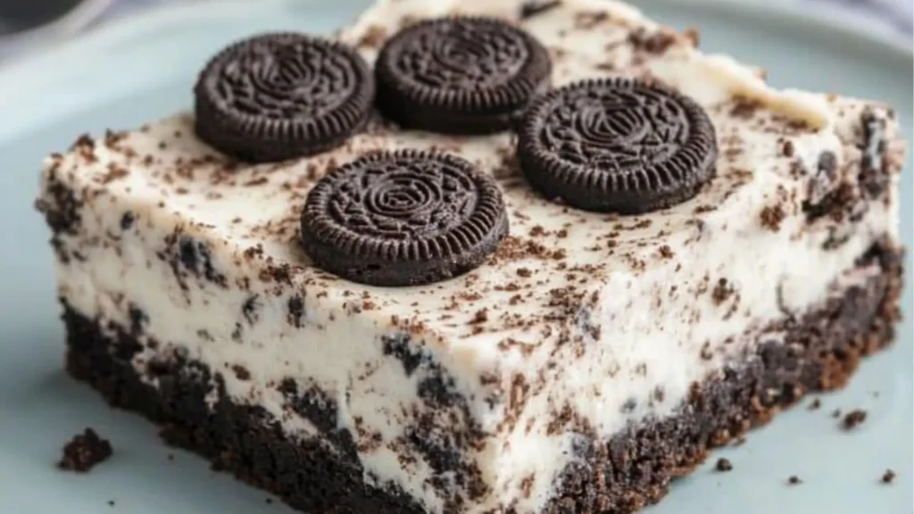 Keto Oreo Cheesecake Bars. Delicious cheesecake with low carb oreo crust and and topping! These cookies and cream bars are super fun looking and a great way to get your kids interested in a healthy treat!