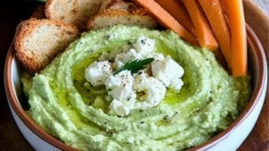 avocado feta dip in a bowl with tortilla chips on the side