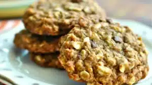 pumpkin oat cookies stacked on top of each other with chocolate chips in the middle