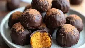 A fall treat featuring homemade truffles! With a dark chocolate coating and lots of cozy spices, these Healthy Pumpkin Truffles are a delicious Thanksgiving dessert idea. This simple pumpkin recipe is also vegan, clean eating, low fat, low sugar, dai...