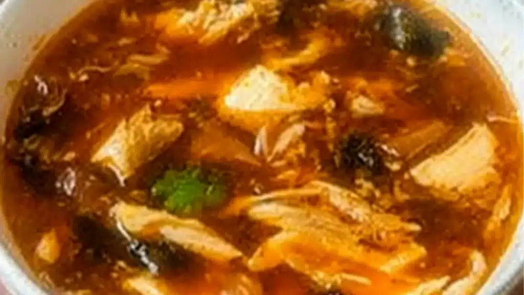 someone is stirring soup in a pot with a ladle and the title reads chinese new year, the best hot & sour soup