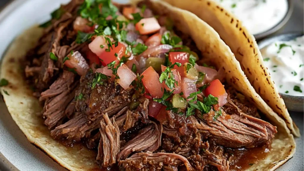 slow - cooked chuck roast tacos with salsa and cilantro on the side