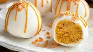 no bake pumpkin cheesecake balls on a white plate