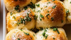 garlic butter dinner rolls in a white bowl with text overlay that reads the best garlic butter dinner rolls