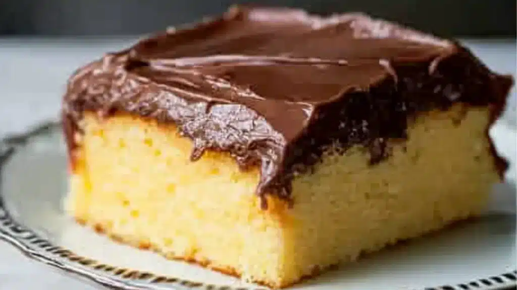 boston cream poke cake is being drizzled with chocolate on the top and bottom