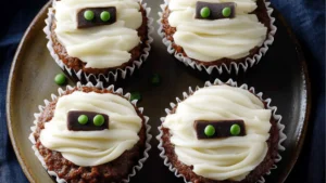cupcakes with white frosting and spooky eyes