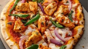 someone is taking a slice of pizza with chicken and veggies on the side