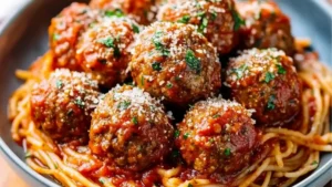 Italian meatballs served over a bowl of spaghetti