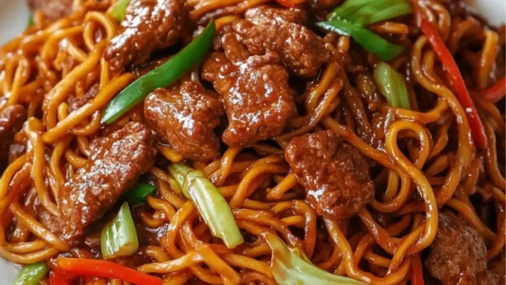 beef lo mein with noodles and vegetables on a plate