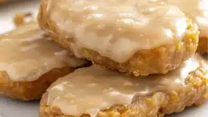 there are several donuts with frosting on the plate and in the middle one is glazed
