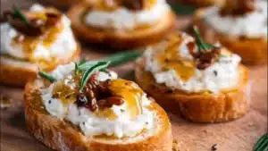 sweet and spicy whipped feta crostini with hot honey on a cutting board