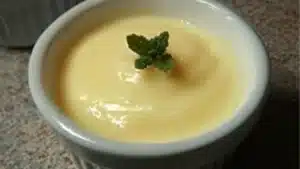 a bowl filled with vanilla pudding next to another bowl full of whipped cream and the words, carnivore vanilla pudding