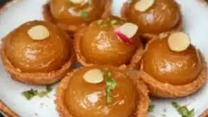 small food items displayed on wooden board with bowl in background