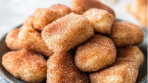sweet cinnamon sugar biscuit bites in a bowl with the words sweet cinnamon sugar biscuit bites