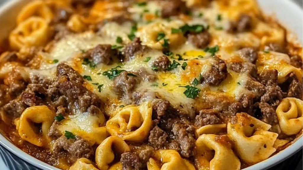 a casserole dish with meat, cheese and sauce in it on a table