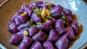 homemade purple sweet potato gnocchini with basil and lemon