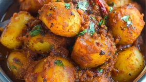 some food is sitting in a bowl on a table and the words bombay potatoes are above it