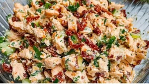 chicken salad sandwich with sun dried tomatoes and tomato sauce on the side is shown in three different pictures