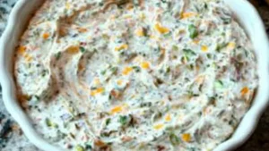 This image shows a bowl filled with creamy jalapeno dip, perfect for parties or a casual snack. It has a smooth texture with bits of green jalapeno inside. You can almost taste the spicy goodness from this picture.