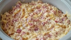 crockpot reuben dip recipe in a white casserole dish with text overlay