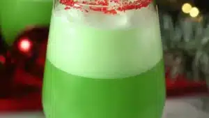 glasses filled with green drinks on top of a table
