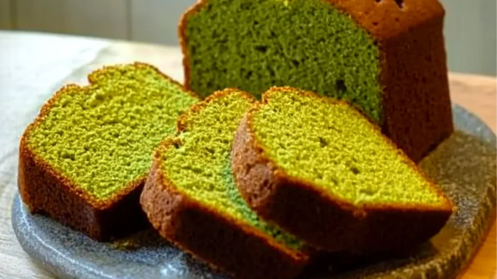 japanese matcha pound cake on a plate with green icing in the middle and below