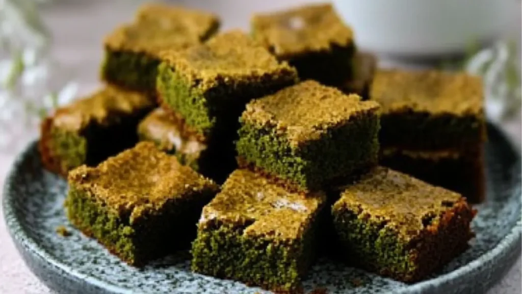 matcha brownies on a white plate with text overlay that reads rich and fluffy matcha brownies