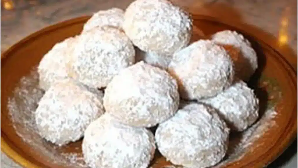 mexican wedding cookies on a plate with the title