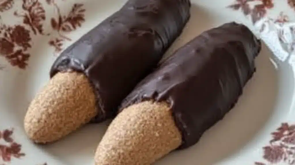chocolate covered cookies in a basket with almonds on the side and nuts scattered around