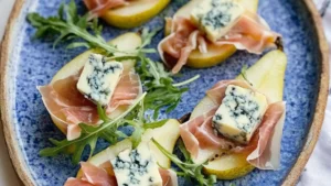 pears and prosciutto with blue cheese on them