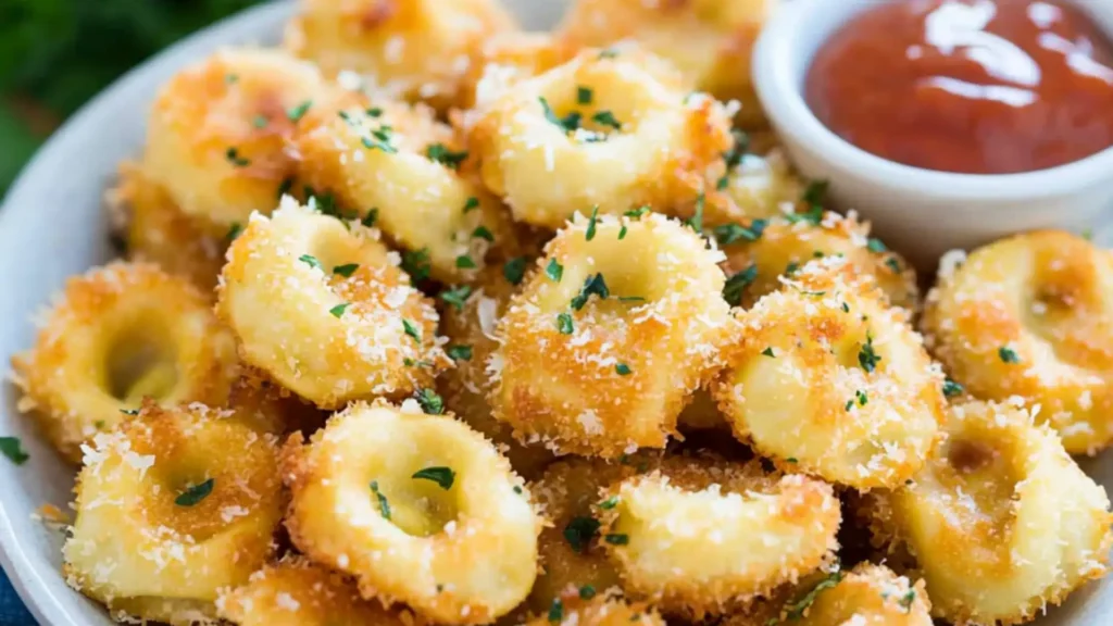 this is an image of parmesan crusted tortelli bites with dipping sauce